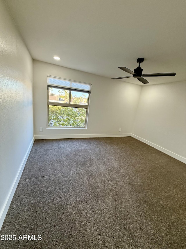 carpeted empty room featuring ceiling fan