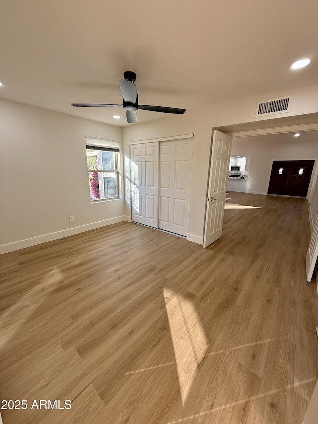 unfurnished bedroom featuring ceiling fan and light hardwood / wood-style floors