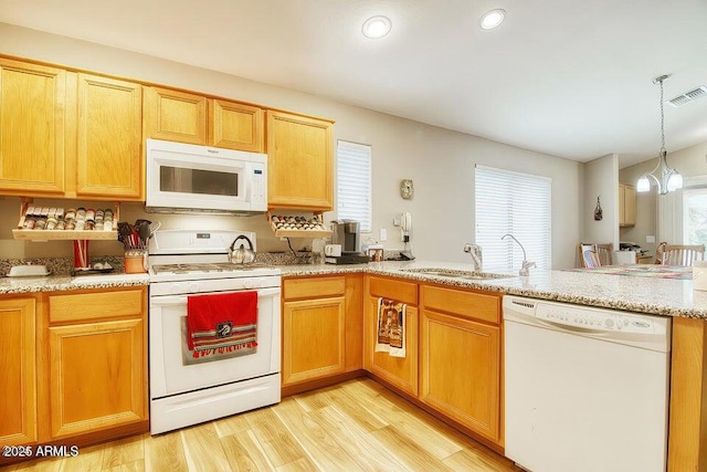 kitchen with pendant lighting, sink, white appliances, a chandelier, and light wood-type flooring