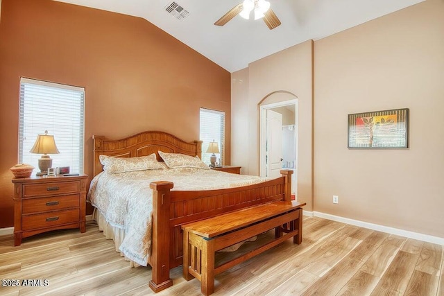 bedroom featuring ceiling fan, high vaulted ceiling, connected bathroom, and light hardwood / wood-style floors