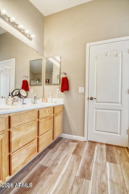 bathroom featuring vanity and hardwood / wood-style floors