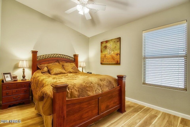 bedroom with ceiling fan, lofted ceiling, and light hardwood / wood-style floors