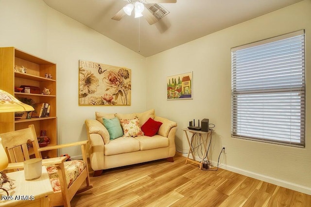 living area featuring vaulted ceiling, ceiling fan, and light hardwood / wood-style floors