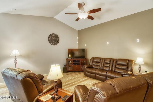 living room featuring lofted ceiling, ceiling fan, and light wood-type flooring