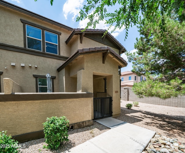 14870 W Encanto Blvd Unit 1059, Goodyear, AZ 85395 - view of front of property with stucco siding and a gate