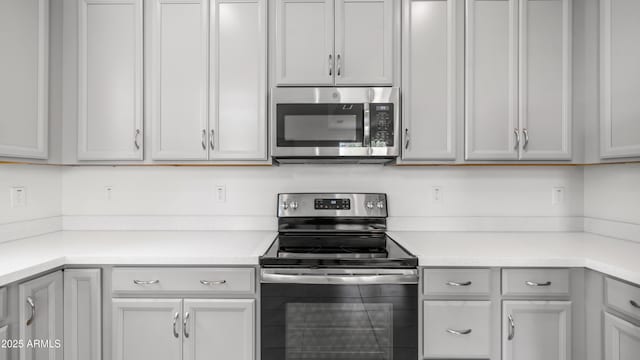 14870 W Encanto Blvd Unit 1059, Goodyear, AZ 85395 - kitchen featuring appliances with stainless steel finishes, light countertops, and gray cabinets