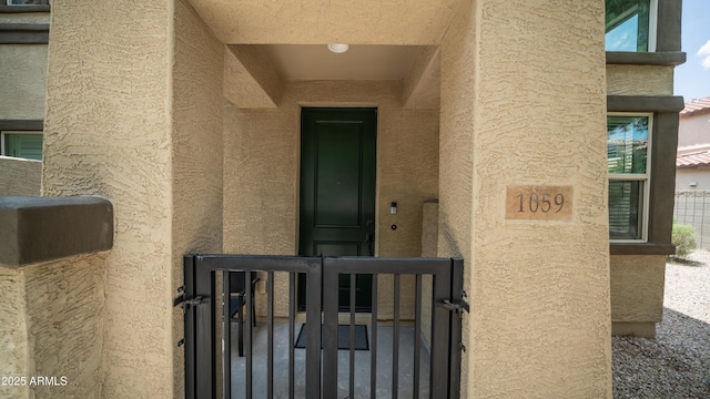 14870 W Encanto Blvd Unit 1059, Goodyear, AZ 85395 - property entrance with stucco siding and a gate