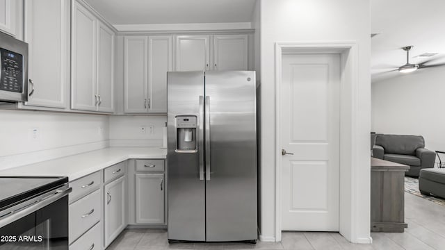 14870 W Encanto Blvd Unit 1059, Goodyear, AZ 85395 - kitchen with appliances with stainless steel finishes, gray cabinetry, light tile patterned floors, light countertops, and ceiling fan