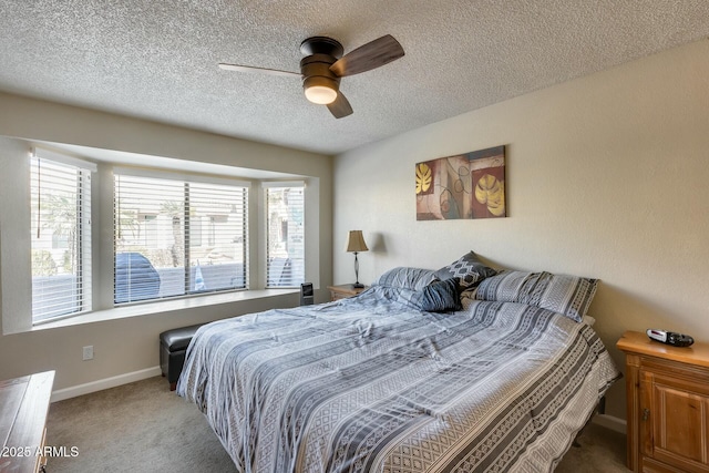 carpeted bedroom featuring a textured ceiling, ceiling fan, and multiple windows