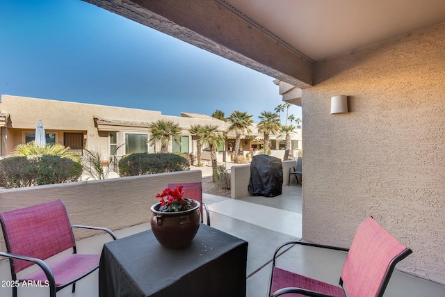 view of patio featuring a balcony and a grill