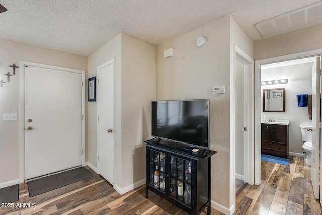 foyer with a textured ceiling and hardwood / wood-style floors