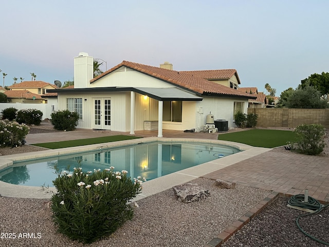 1044 N Arvada N, Mesa, AZ 85205 - back of property featuring a chimney, french doors, a patio, a fenced backyard, and a tile roof