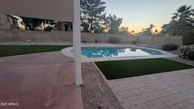1044 N Arvada N, Mesa, AZ 85205 - pool at dusk featuring a fenced backyard and a patio