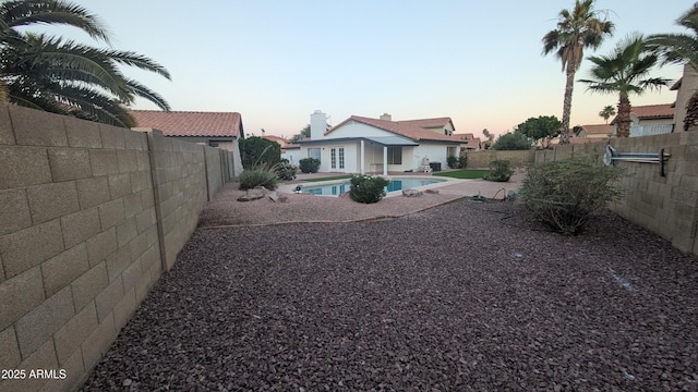 1044 N Arvada N, Mesa, AZ 85205 - yard at dusk featuring a fenced backyard and a patio area