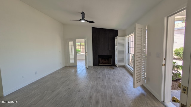 1044 N Arvada N, Mesa, AZ 85205 - unfurnished living room with lofted ceiling, ceiling fan, a fireplace, and wood finished floors