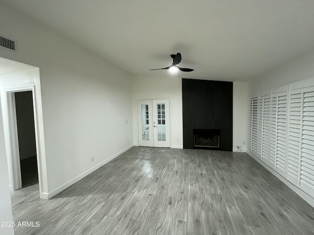 1044 N Arvada N, Mesa, AZ 85205 - unfurnished living room with ceiling fan, lofted ceiling, wood finished floors, a fireplace, and french doors