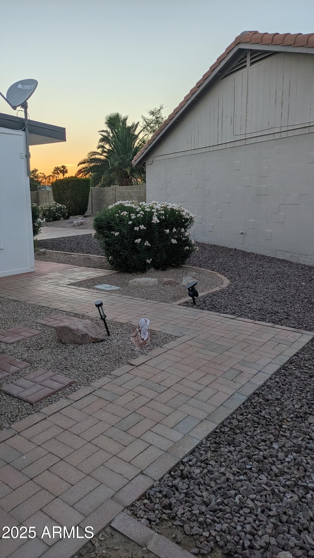 1044 N Arvada N, Mesa, AZ 85205 - yard at dusk featuring a patio area