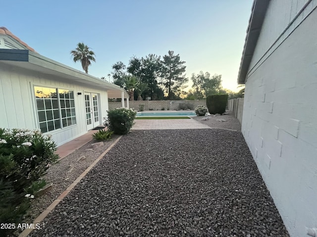 1044 N Arvada N, Mesa, AZ 85205 - yard at dusk with a fenced backyard and a patio area