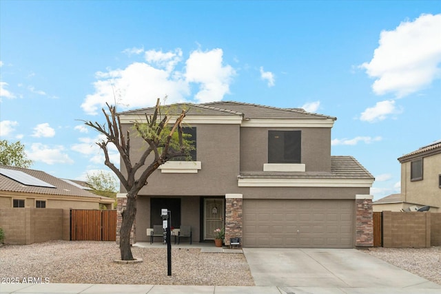 view of front of property featuring a garage, a tile roof, concrete driveway, and stucco siding