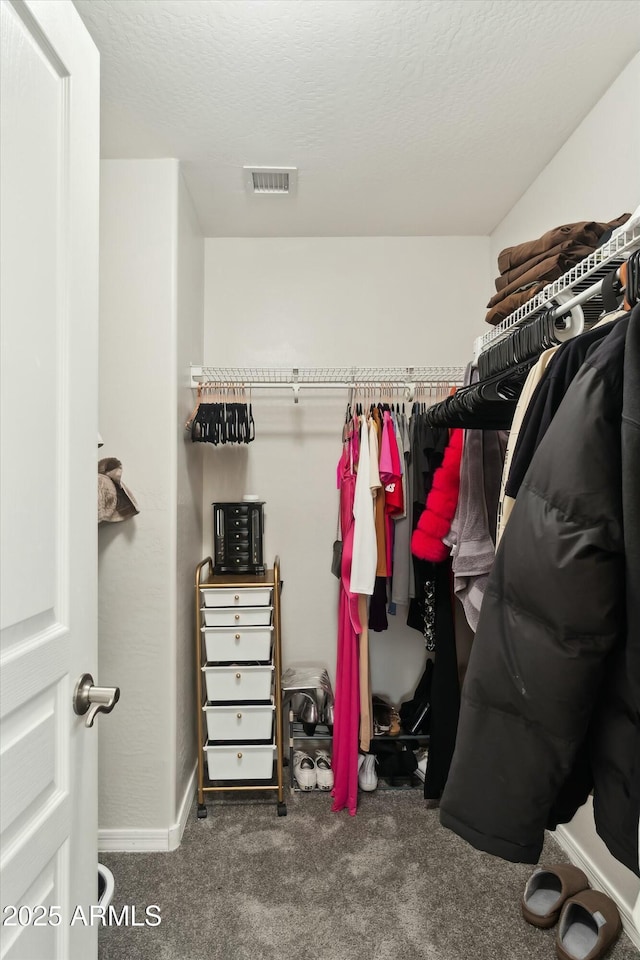 walk in closet featuring carpet flooring and visible vents