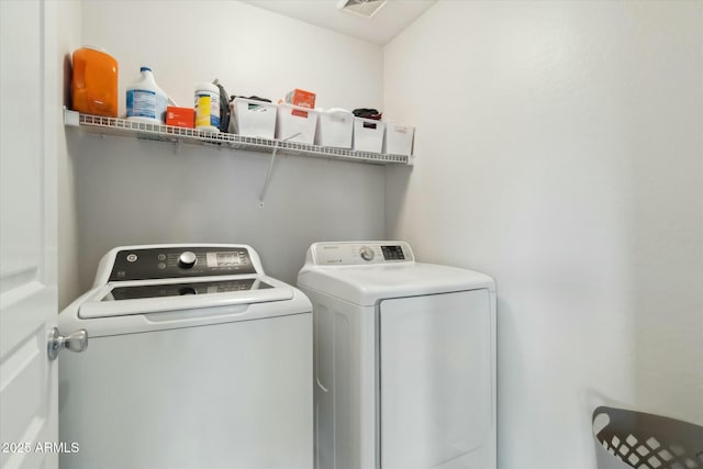 washroom featuring laundry area and washer and clothes dryer