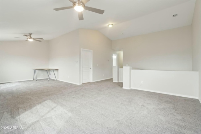 unfurnished room featuring vaulted ceiling, carpet floors, ceiling fan, and baseboards