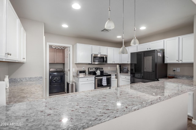 kitchen with washer / clothes dryer, pendant lighting, stainless steel appliances, and white cabinetry