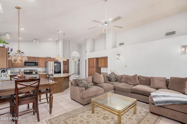 9414 S La Rosa Dr, Tempe, AZ 85284 - living room with arched walkways, ceiling fan, high vaulted ceiling, and light tile patterned flooring