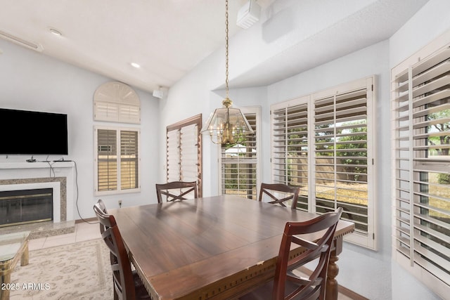 9414 S La Rosa Dr, Tempe, AZ 85284 - dining area with a chandelier, lofted ceiling, and a fireplace