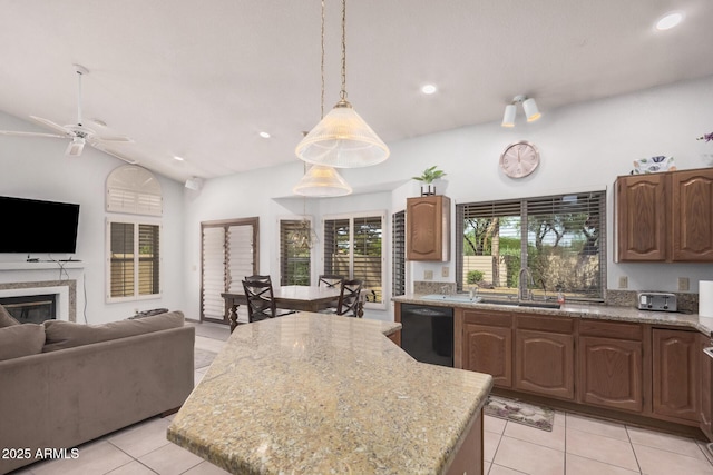 9414 S La Rosa Dr, Tempe, AZ 85284 - kitchen with black dishwasher, open floor plan, a sink, light tile patterned floors, and light stone counters