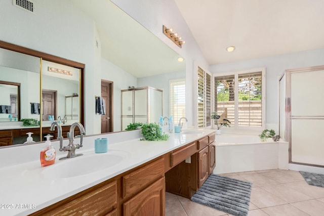 9414 S La Rosa Dr, Tempe, AZ 85284 - full bathroom featuring vaulted ceiling, a stall shower, a garden tub, double vanity, and tile patterned floors
