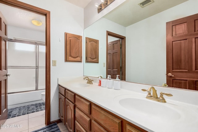 9414 S La Rosa Dr, Tempe, AZ 85284 - full bathroom with toilet, double vanity, shower / bath combination with glass door, and tile patterned floors