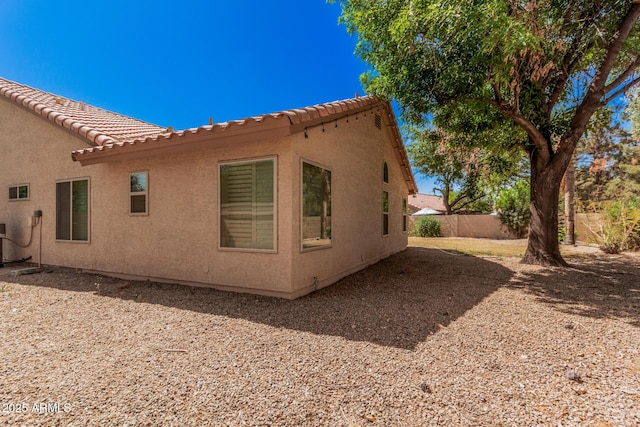 9414 S La Rosa Dr, Tempe, AZ 85284 - back of house with fence, stucco siding, a tiled roof, and central AC