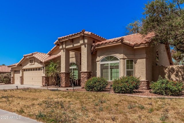 9414 S La Rosa Dr, Tempe, AZ 85284 - mediterranean / spanish-style house featuring a tiled roof, a garage, stucco siding, driveway, and a front yard