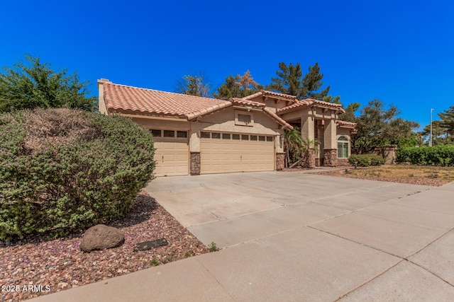 9414 S La Rosa Dr, Tempe, AZ 85284 - mediterranean / spanish house featuring stucco siding, a garage, a tile roof, and driveway
