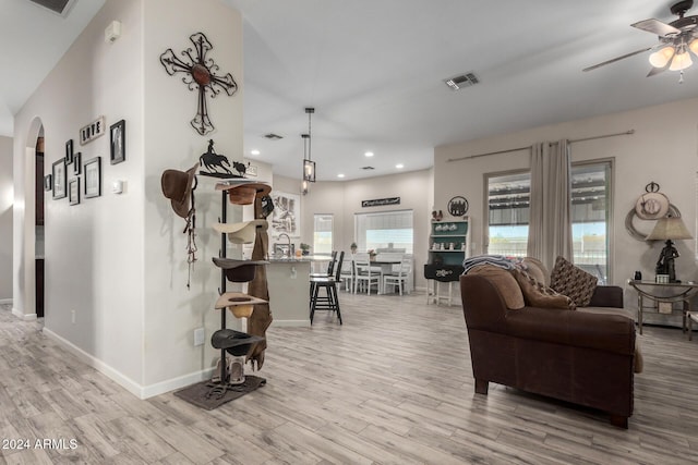 living room featuring ceiling fan and light wood-type flooring