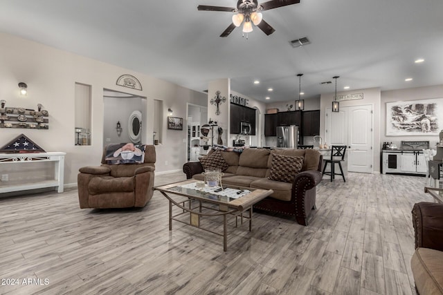 living room with ceiling fan and light hardwood / wood-style floors