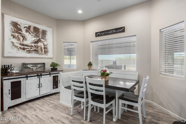 dining space with wine cooler and light wood-type flooring