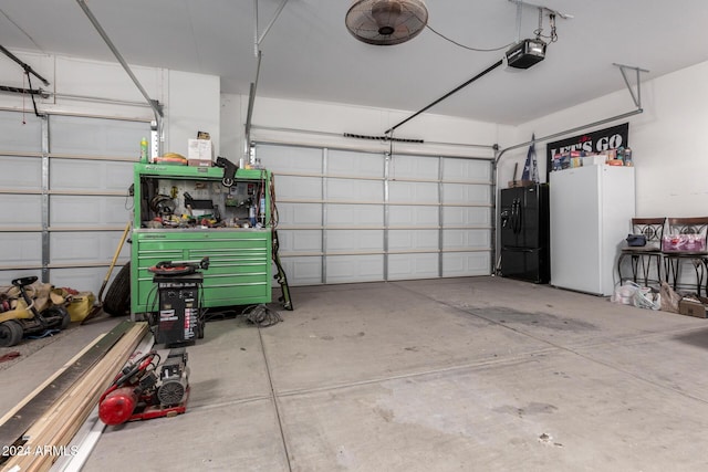 garage with a garage door opener and black refrigerator with ice dispenser