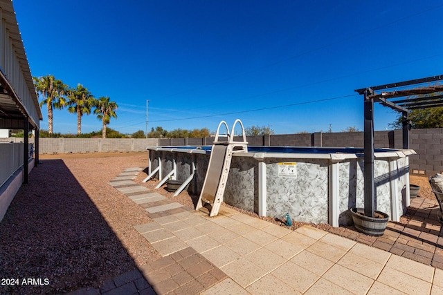 view of patio featuring a fenced in pool