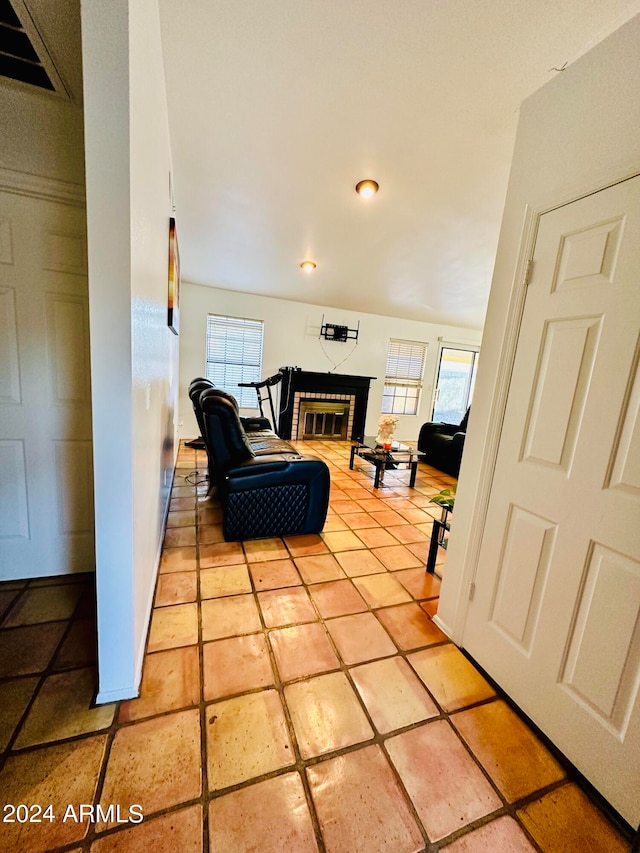 living area with light tile patterned flooring and plenty of natural light