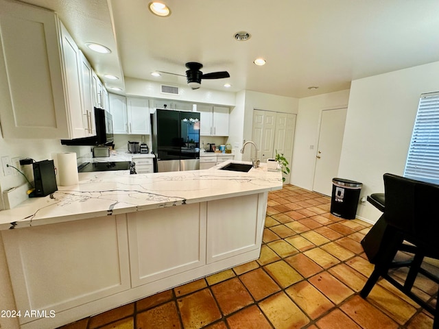 kitchen featuring white cabinets, black appliances, kitchen peninsula, and ceiling fan