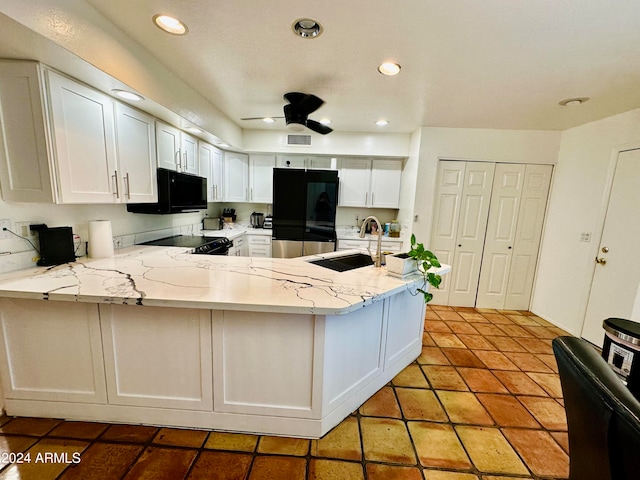 kitchen featuring kitchen peninsula, black appliances, ceiling fan, and sink