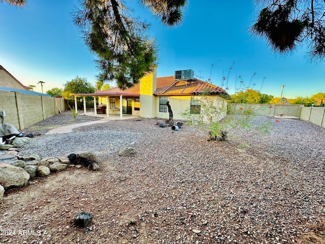 rear view of house with a patio area and central air condition unit