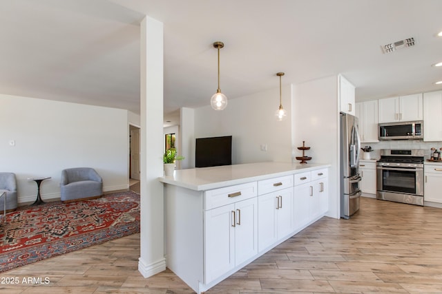 kitchen with visible vents, light wood-type flooring, open floor plan, and appliances with stainless steel finishes