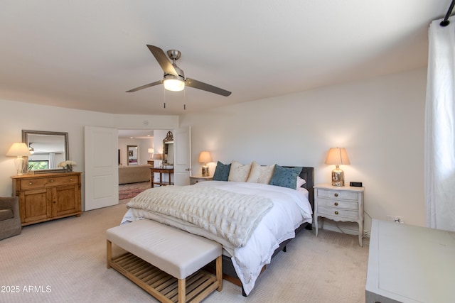 bedroom with ceiling fan and light carpet