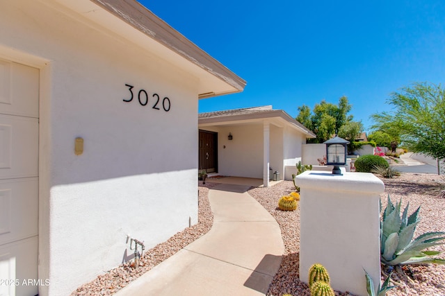 view of exterior entry with stucco siding