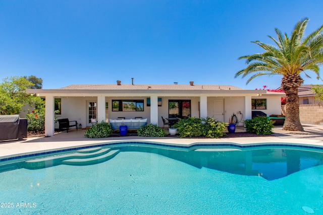 pool featuring area for grilling and a patio