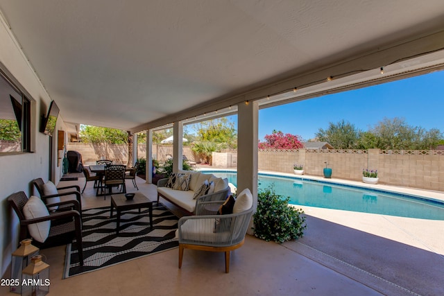 view of patio with an outdoor living space, a fenced in pool, outdoor dining area, and a fenced backyard