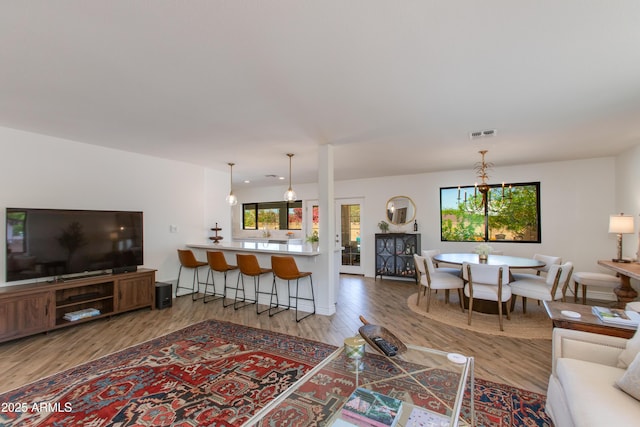 living room featuring wood finished floors and visible vents